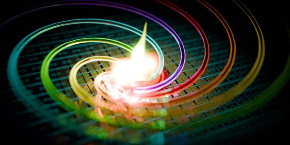 Artistic impression of the deep-strong coupling achieved. Rainbow colored spirals on a microstructured surface.